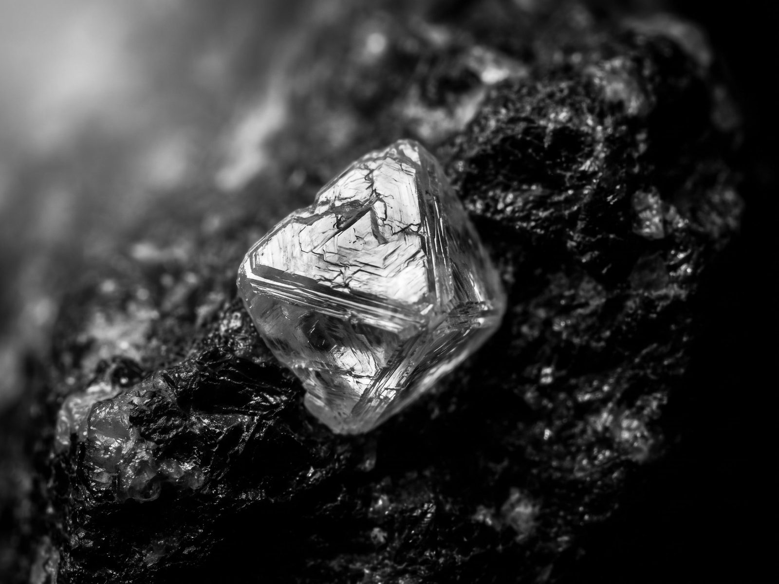 Rough natural diamond crystal in kimberlite rock